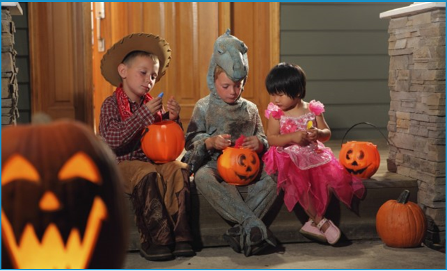 Three children in Halloween costumes