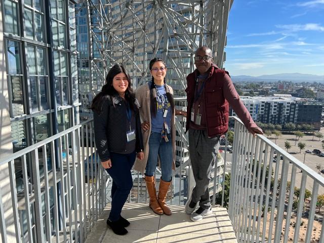 Triad of SDPL staff smiling on the terrace at Central Library