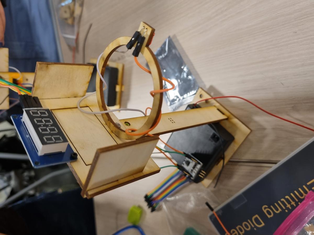 Tabletop laser cut wood basketball hoop with wires and electronic scoreboard