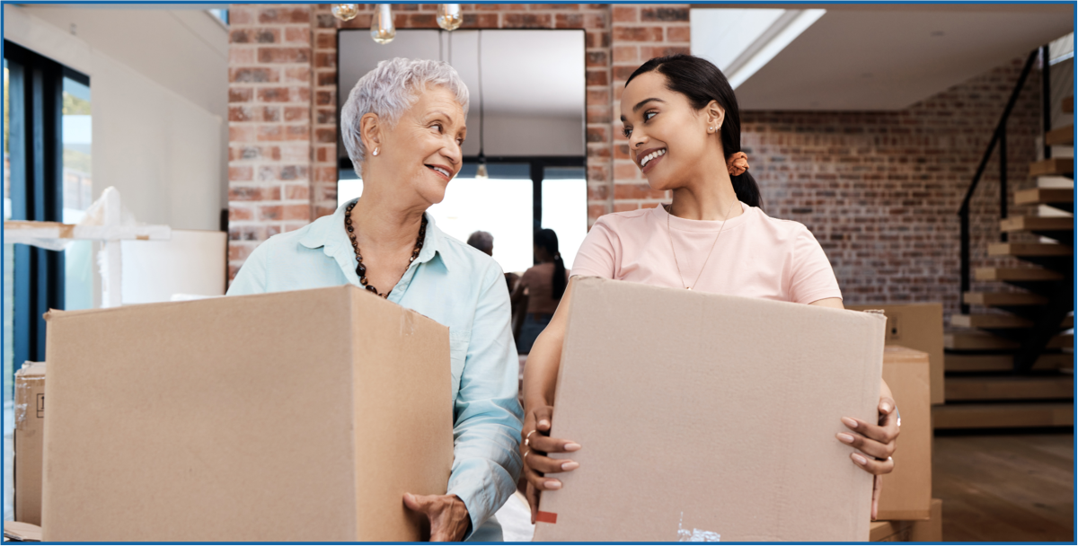 Photo of two women moving boxes