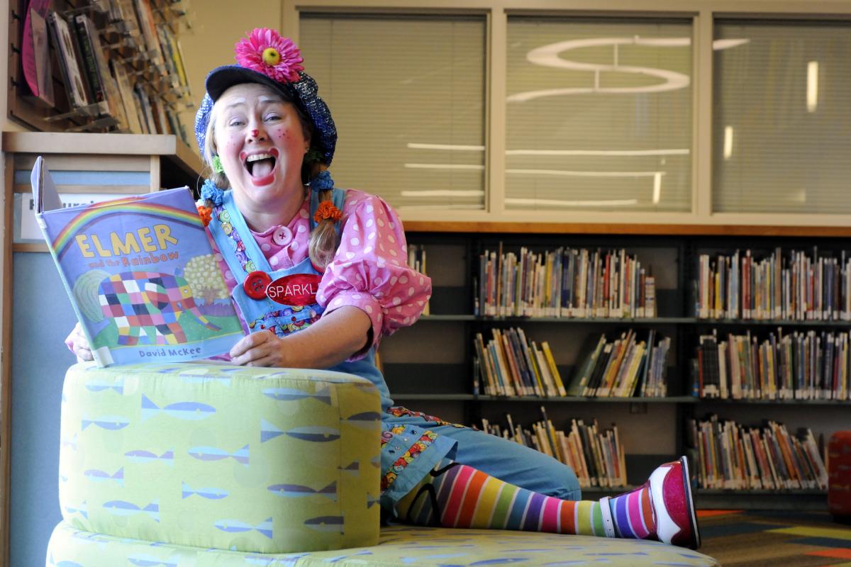 Sparkles the clown reading a children's book