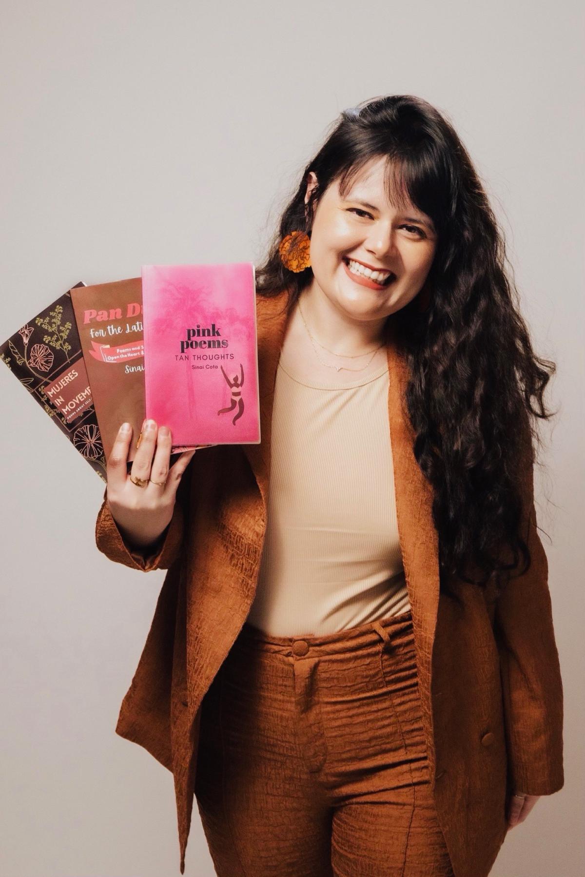 Sinai Cota holding three of her books.