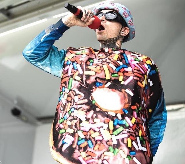 Man singing while wearing a donut costume.