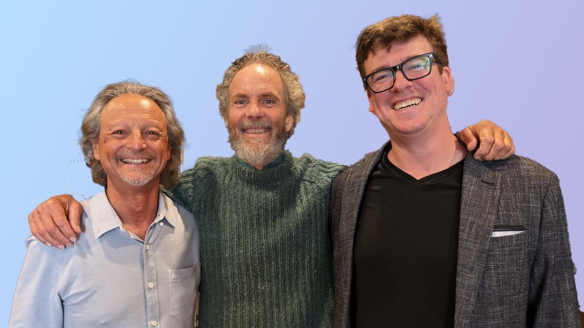 Photo of three men (Fred Benedetti, Peter Sprague, Mack Leighton) standing in front of a blue background