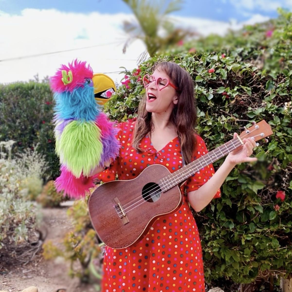 Miss Marae with guitar & parrot puppet