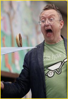 Man watching hamburger roll on umbrella