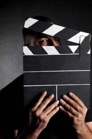 Man holding a clap board.