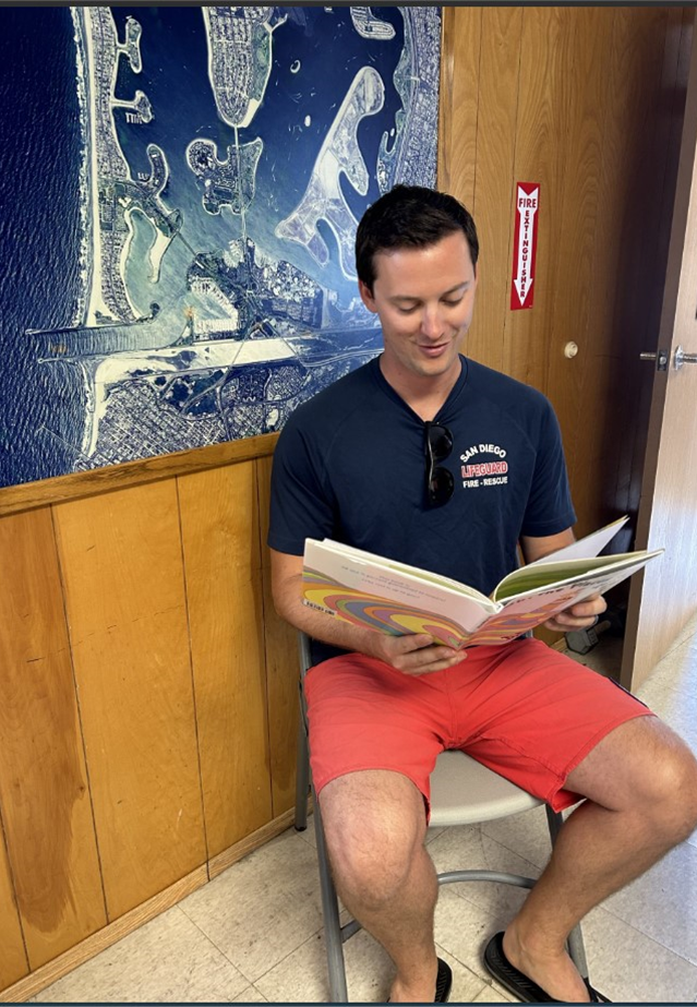 Lifeguard reading a book