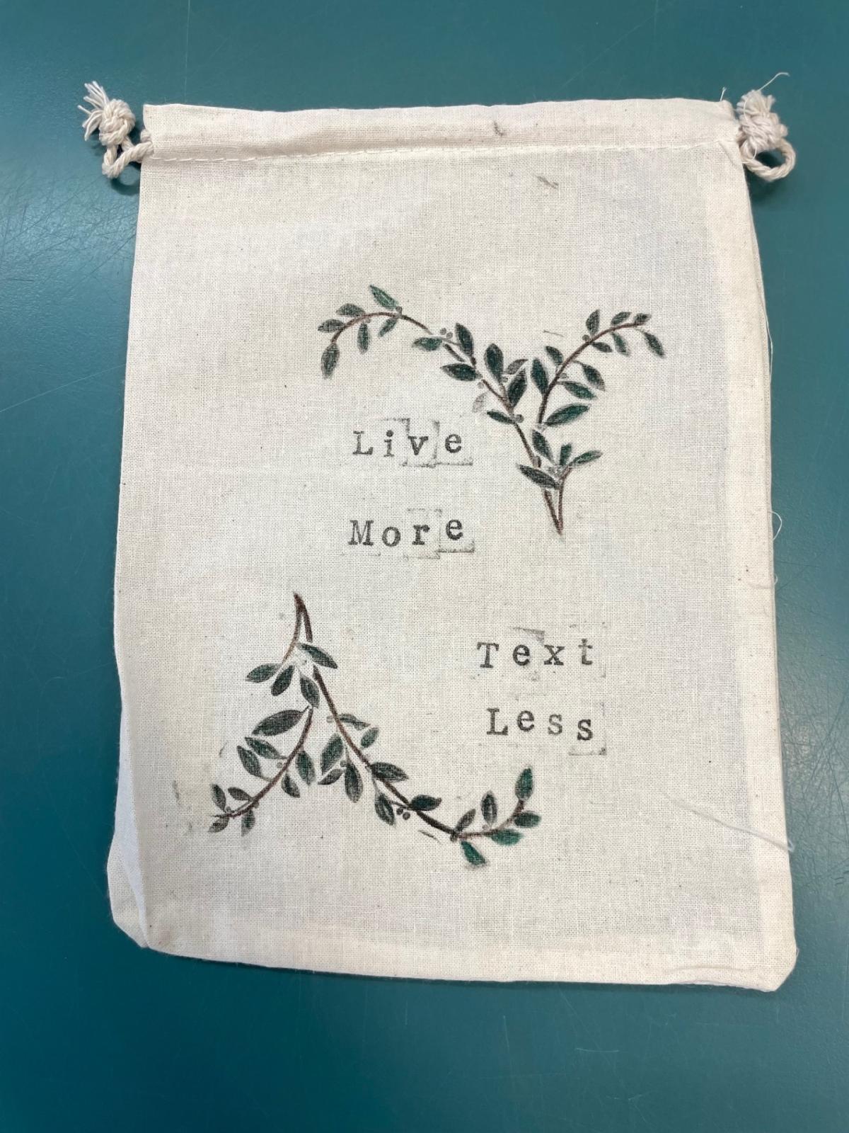 Bag reads "live more text less"