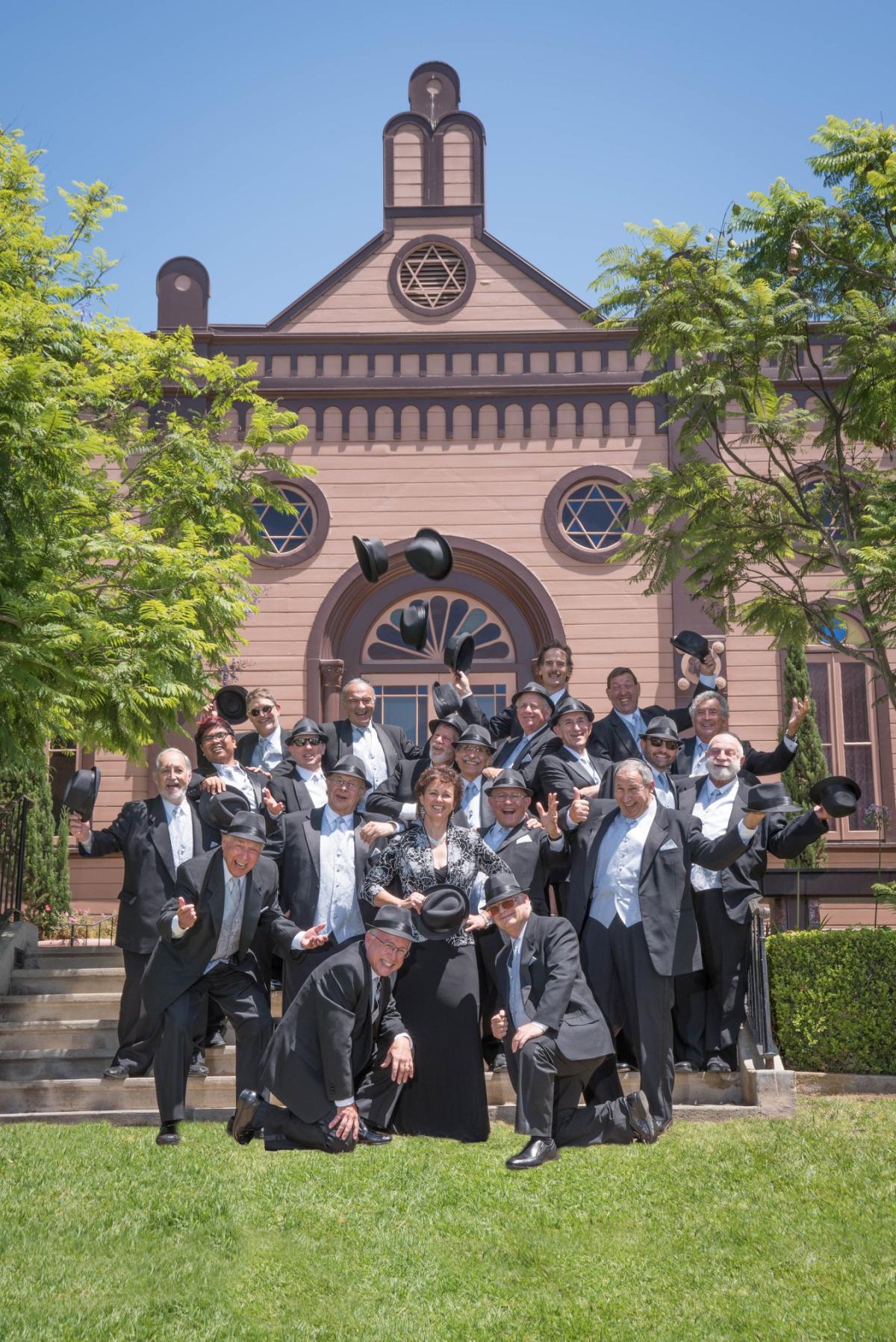 Members of San Diego Jewish Men's Choir posing for picture outside a building