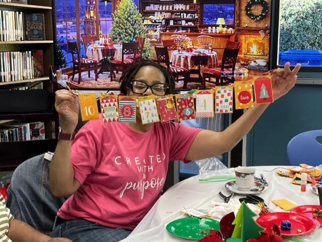 Adult participant enjoying Countdown to Christmas tea garland 