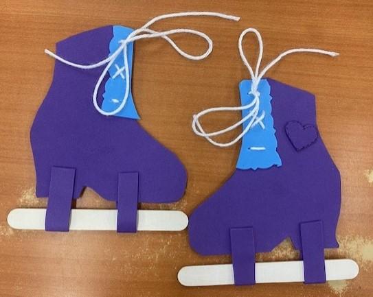 A pair of purple ice skates made out of foam sheets