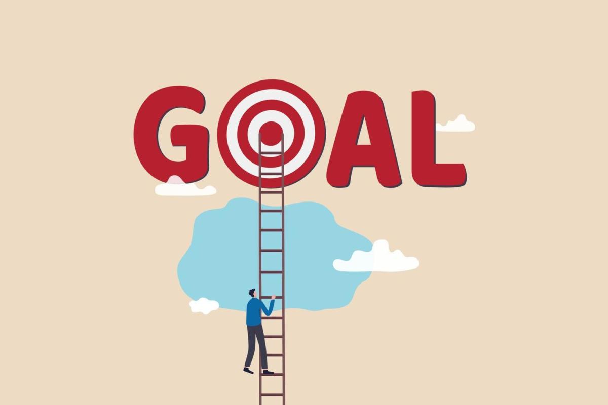 Man climbing on ladder to reach "GOAL"