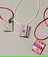 photo of three, handmade mini book charms