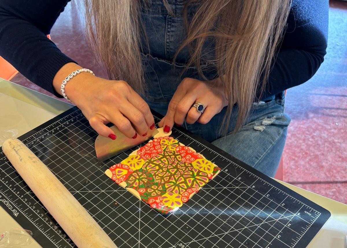 Photo of a person's hands working with colorful polymer clay