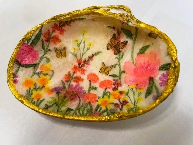 clam shell with floral tissue paper adhered with decoupage and edged in gold paint