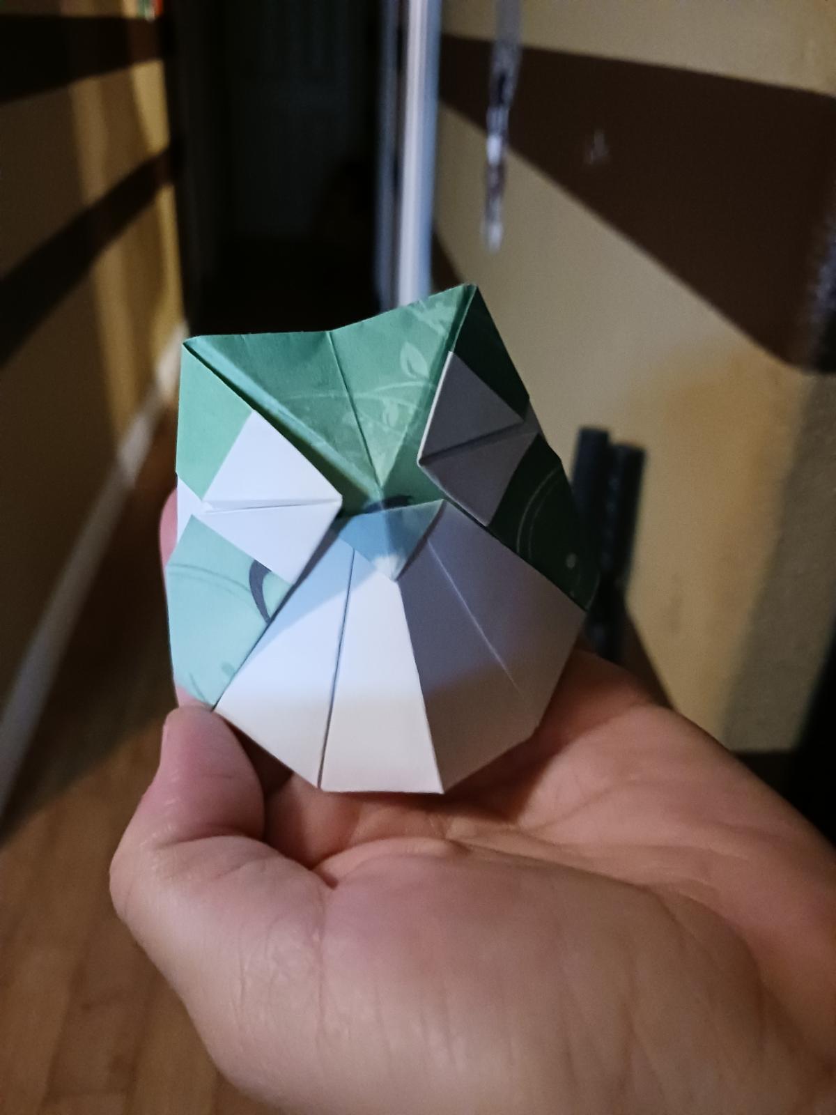 a cute paper owl is held in a person's hand