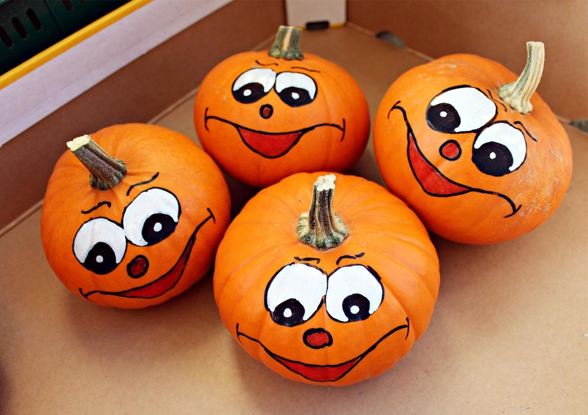 orange pumpkins with painted faces. 