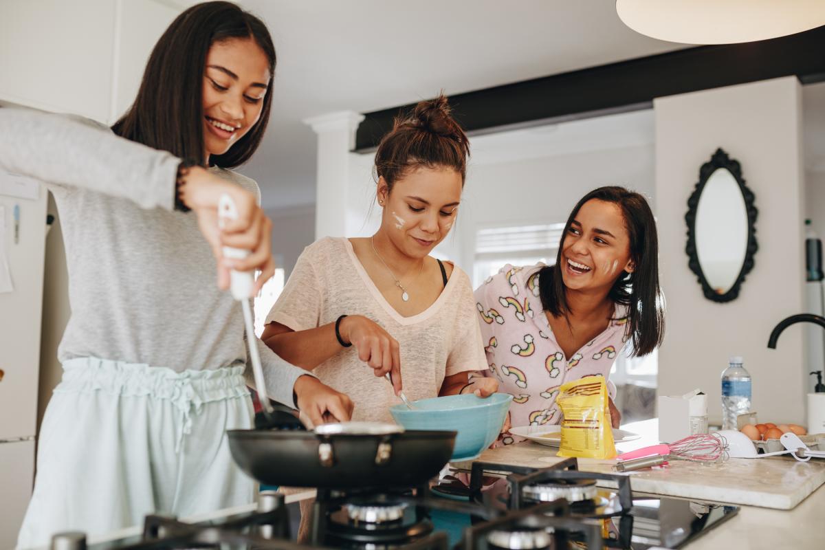 Three teen girls cooking together