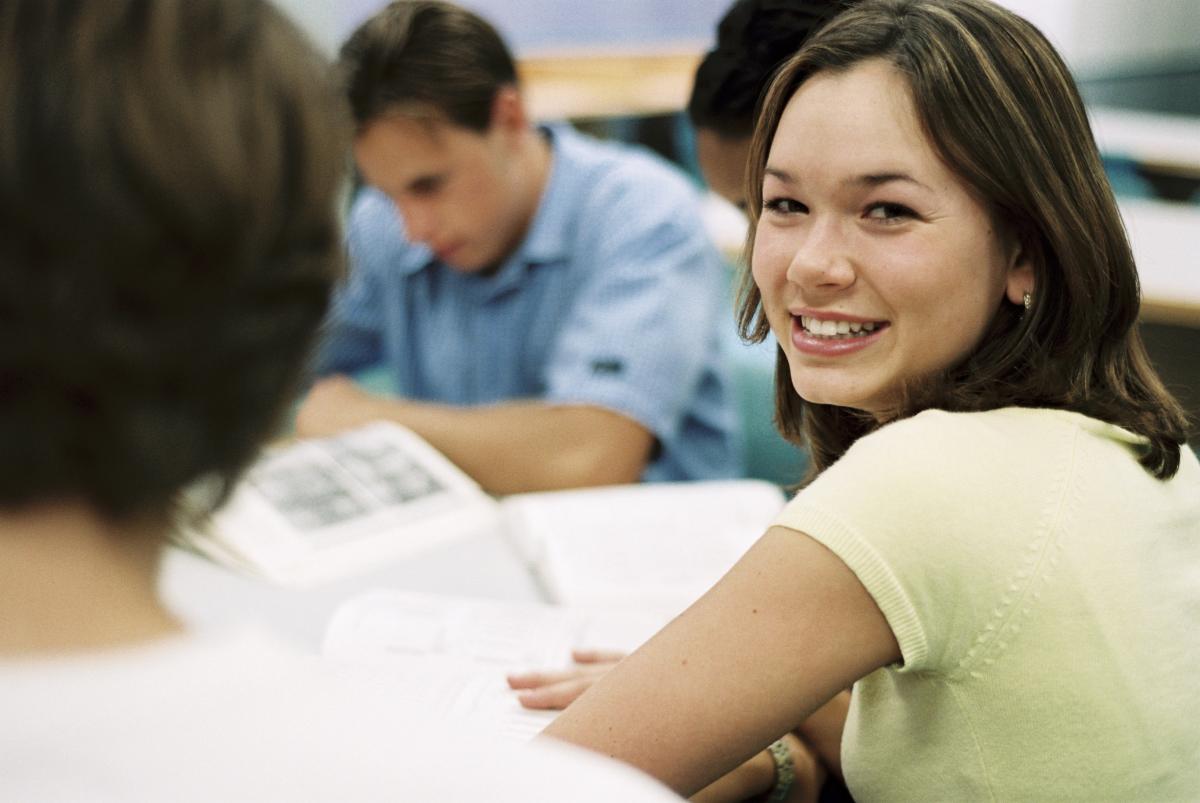 Woman in classroom looking back at camera