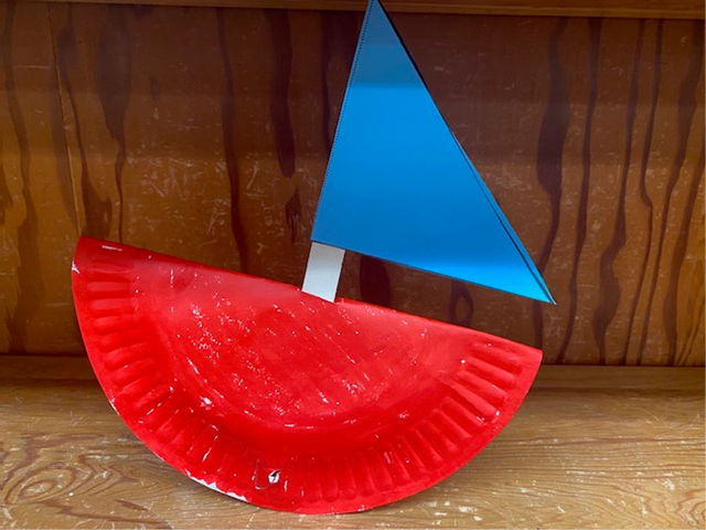 Red paper plate rocking boat with a blue paper sail