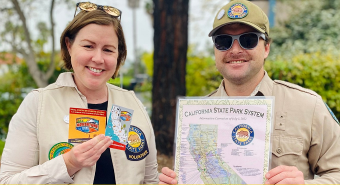 Two park rangers, one woman and one man, stand side by side 
