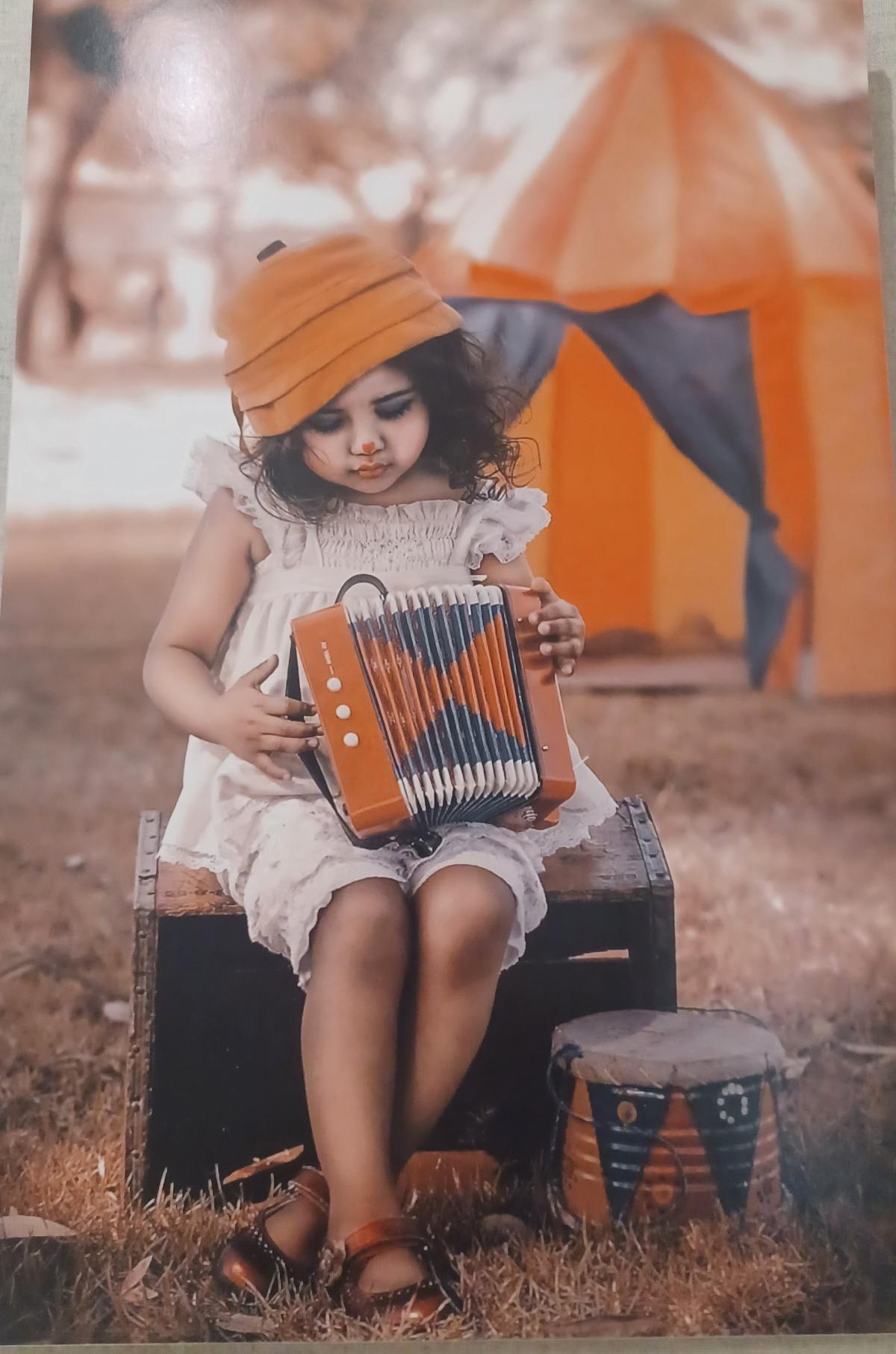 Artistic photograph of child playing accordion