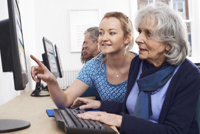 two women looking at a computer screen