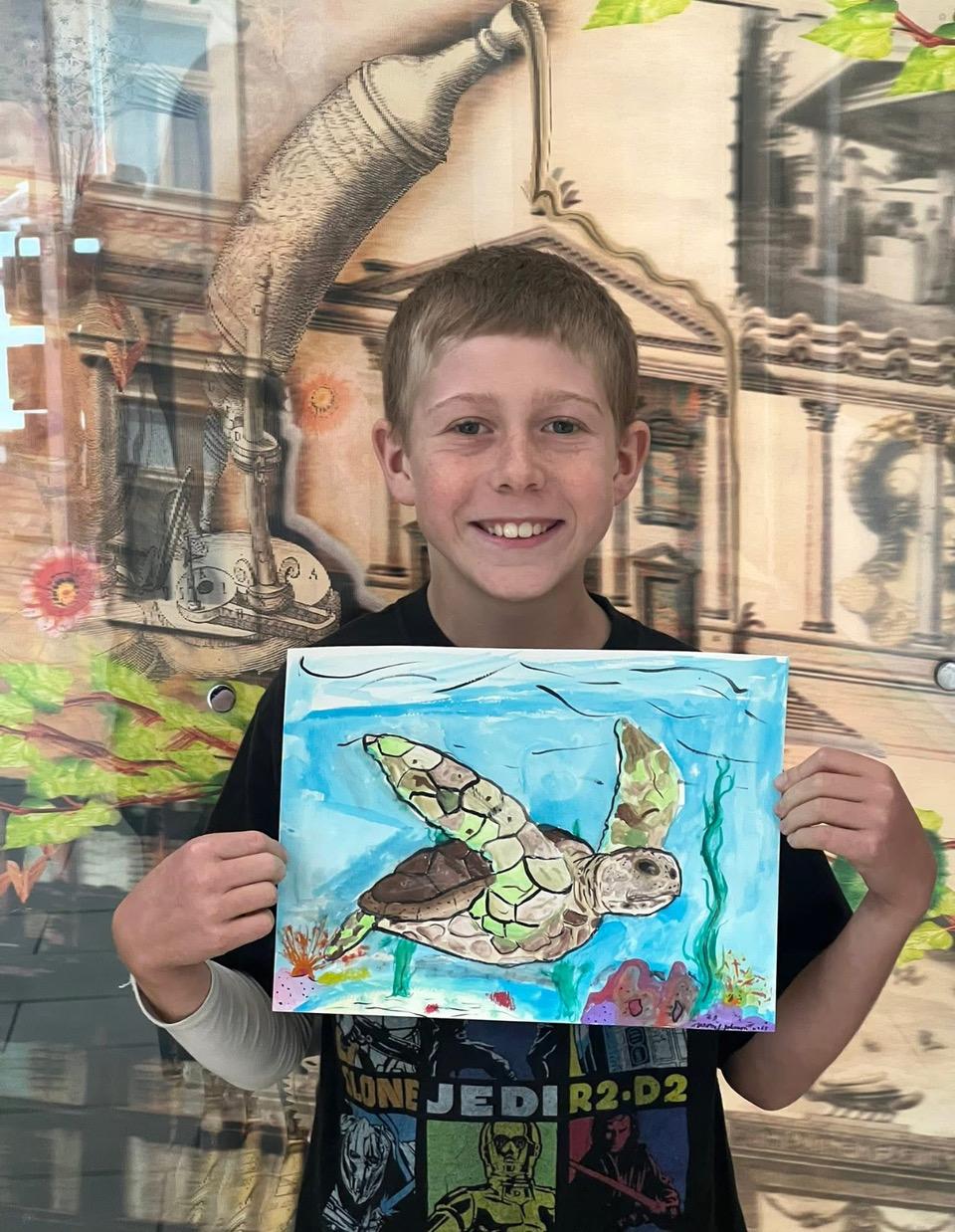 sample image of child holding sea turtle art