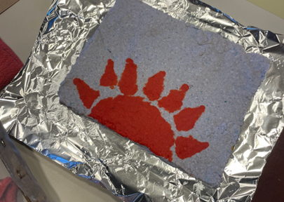 Blue sheet of paper with red sun image on it