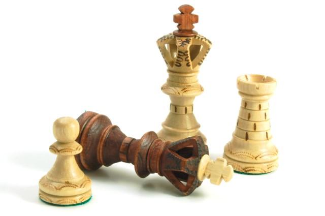 Four chess pieces: King, queen, bishop, and pawn