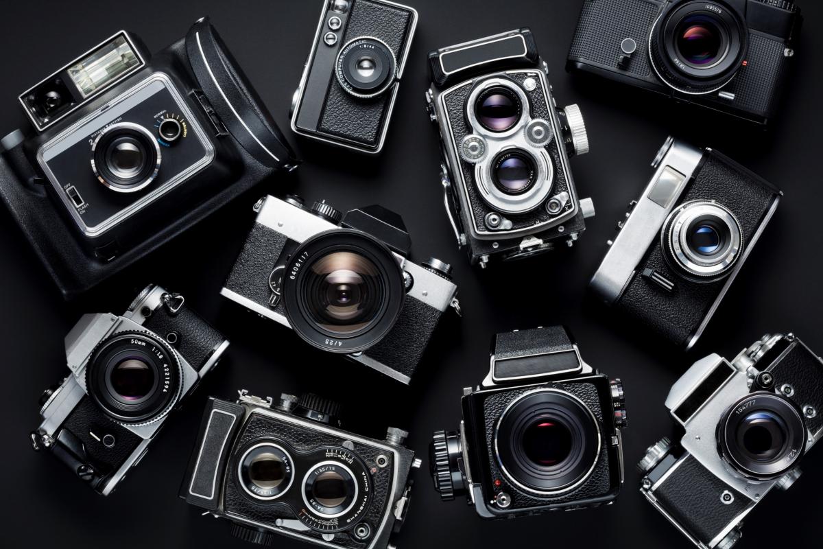 Different models of cameras against black background