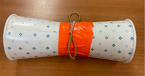 Two paper cups taped together at the bottom with a rubber band chain wrapped around the center