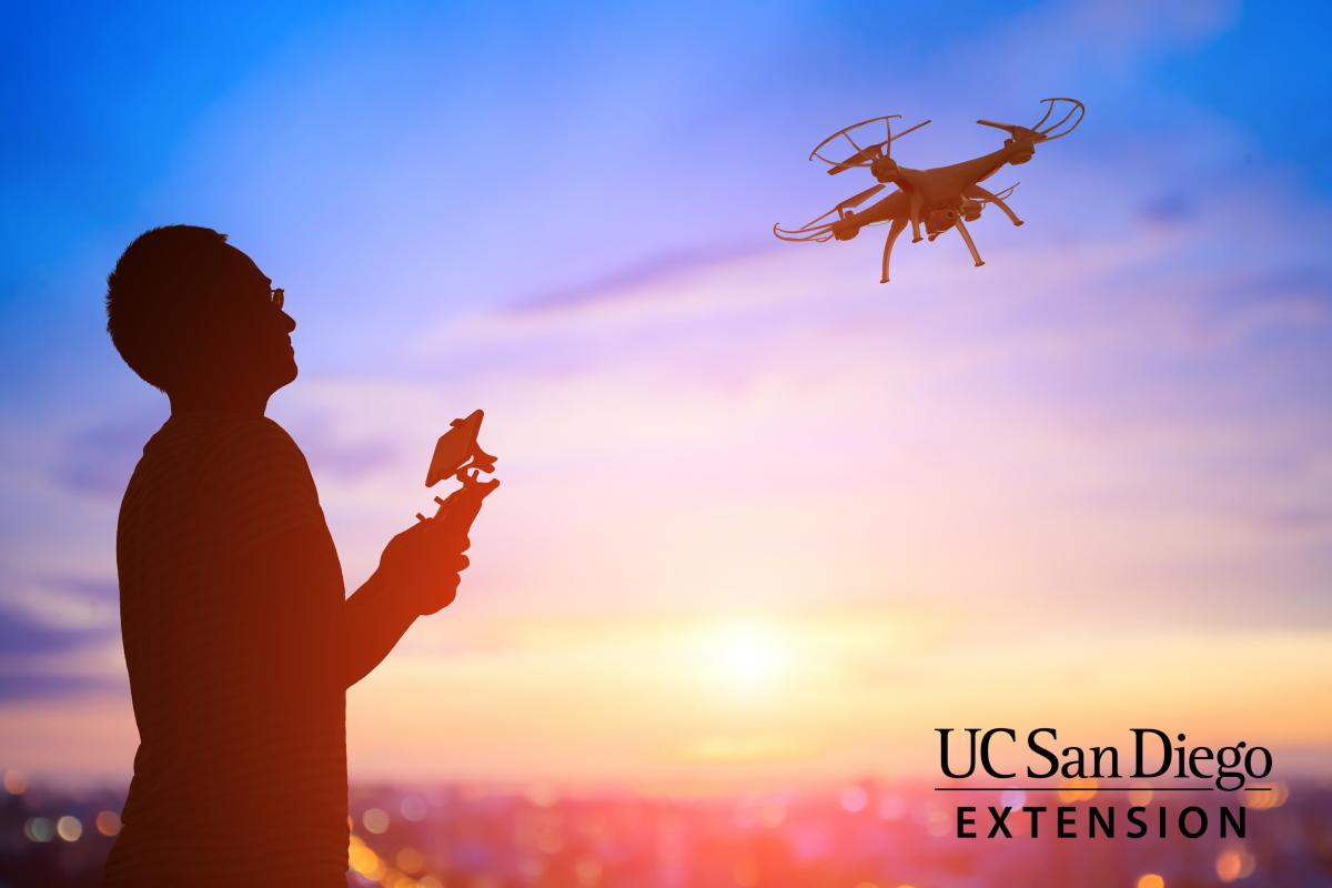 drone flying with operator in foreground