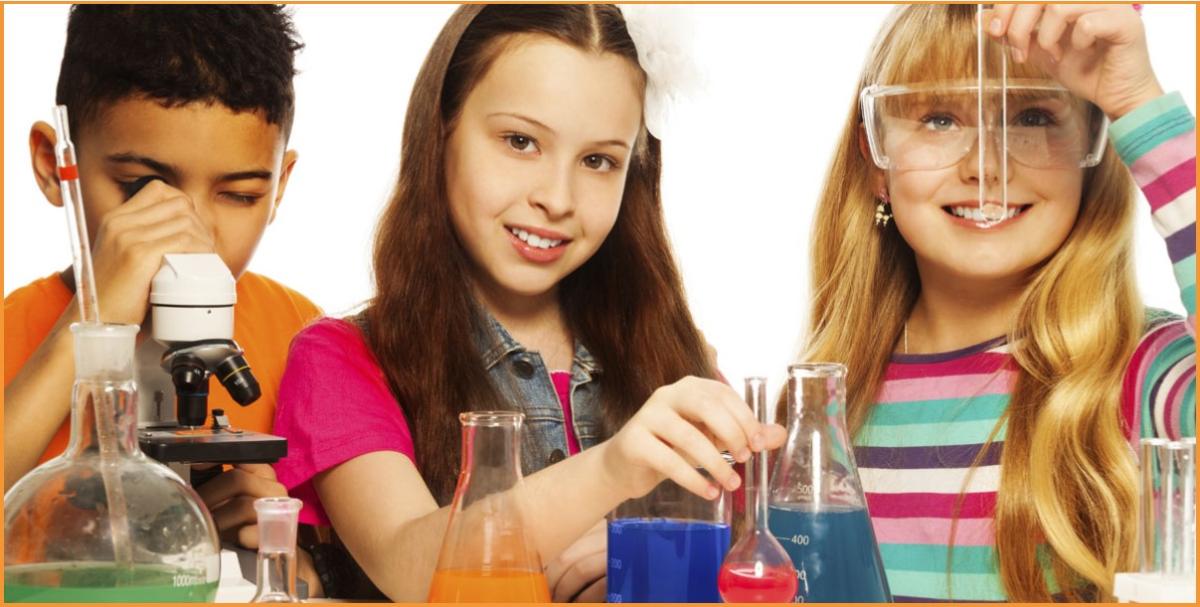 A boy and two girls using a microscope and test tubes